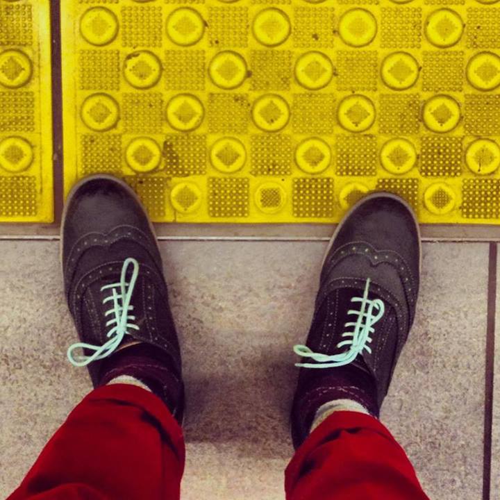 Blue shoes crossing a yellow line