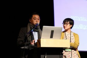 Two people on stage giving presentation