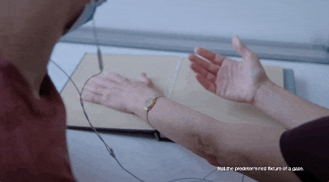 Hands placed on an open book, and one hand turns upward and then the other hand does the same